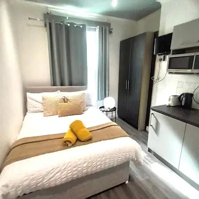 a bedroom with a bed with yellow towels on it at Bold Street Studio III in Liverpool