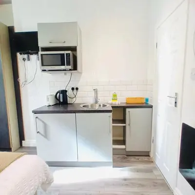 a small kitchen with a sink and a microwave at Bold Street Studio III in Liverpool