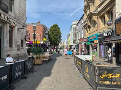 a city street with tables and people walking down the street at Bold Street Studio III in Liverpool