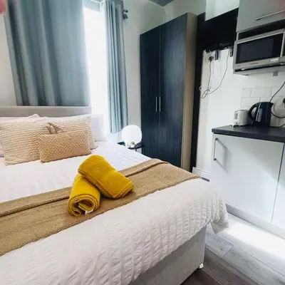 a bedroom with a bed with a yellow towel on it at Bold Street Studio III in Liverpool