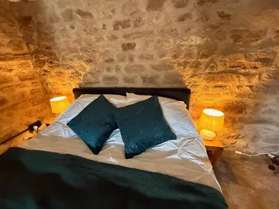 a bedroom with a bed with two pillows on it at The Snug- A beautiful and characterful property connected to a historic Georgian Manor House in Overton