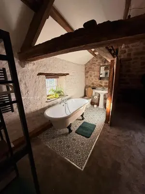 a large bathroom with a tub in a room at The Snug- A beautiful and characterful property connected to a historic Georgian Manor House in Overton