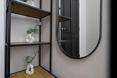 a mirror on a wall next to a room at Sunnie stays apartment harrington chambers in Liverpool