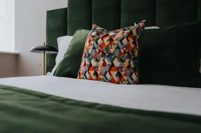 a close up of a bed with a pillow at Sunnie stays apartment harrington chambers in Liverpool