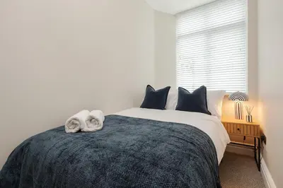 a bedroom with a bed with two towels on it at Sunnie stays apartment harrington chambers in Liverpool
