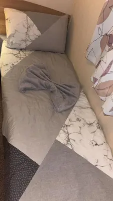a bed with a blanket and pillows on it at Bills place in Heysham