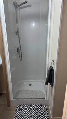 a shower stall in a bathroom with a shower at Bills place in Heysham