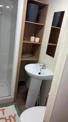 a bathroom with a sink and a shower and a toilet at Bills place in Heysham