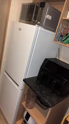 a white refrigerator in a kitchen with a microwave at Bills place in Heysham
