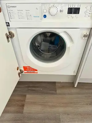 a white washing machine sitting in a room at Chic 2 Apartment Family Home, Near Beach, WIFI, Sleeps 10 in Blackpool
