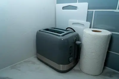 a toaster and a roll of toilet paper in a bathroom at Chic 2 Apartment Family Home, Near Beach, WIFI, Sleeps 10 in Blackpool