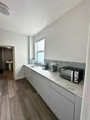 a kitchen with a counter top with a microwave at Chic 2 Apartment Family Home, Near Beach, WIFI, Sleeps 10 in Blackpool