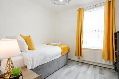 a bedroom with a bed and a window at Newly Renovated 4BR House with lots of amenities in Liverpool