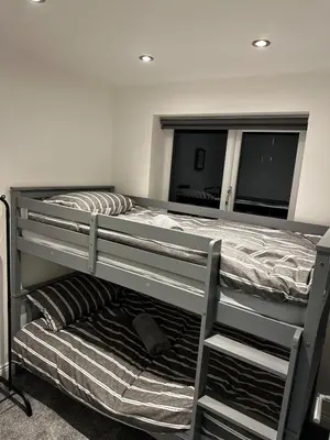 a bedroom with two bunk beds and a mirror at The Scouse Suite in Liverpool