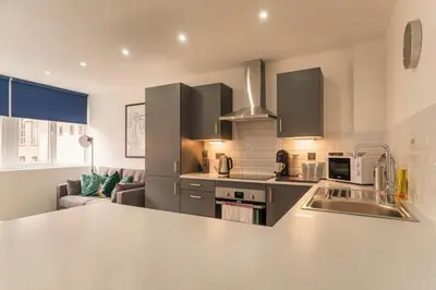 a kitchen with a sink and a counter top at Cosy & Bright 1 Bedroom Preston Apartment in Preston