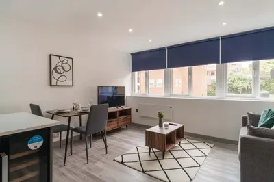a living room with a table and a couch at Cosy & Bright 1 Bedroom Preston Apartment in Preston