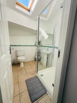 a bathroom with a shower and a toilet and a sink at JMC Place - The Duplex in Blackpool