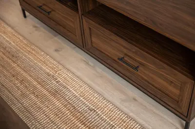 a wooden cabinet with drawers on a wooden floor at Contemporary 1BED Apartment in Central Liverpool in Liverpool