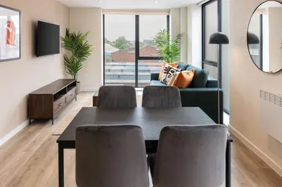 a living room with a table and chairs and a couch at Contemporary 1BED Apartment in Central Liverpool in Liverpool
