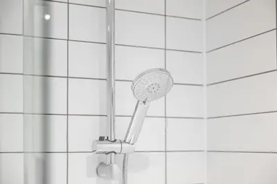 a shower with a shower head in a bathroom at Contemporary 1BED Apartment in Central Liverpool in Liverpool