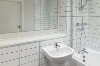 a bathroom with a sink and a mirror and a tub at Contemporary 1BED Apartment in Central Liverpool in Liverpool