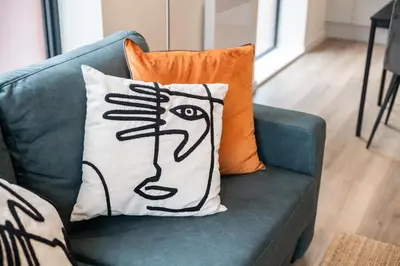 a pillow with a face on it sitting on a couch at Contemporary 1BED Apartment in Central Liverpool in Liverpool