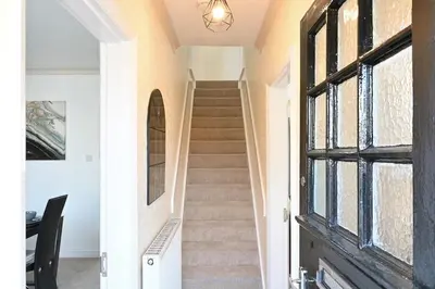 a staircase in a house with a window at Sleek and Stylish 3 Bed in Bolton-Garden-Parking in Bradshaw