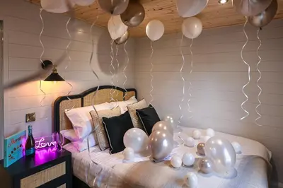 a room with a bed with balloons on it at Staining Luxury Lodges in Poulton le Fylde