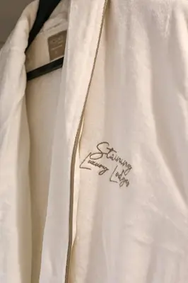 a close up of a white jacket with a signature on it at Staining Luxury Lodges in Poulton le Fylde