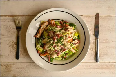 a plate of food with broccoli and meat on a table at Staining Luxury Lodges in Poulton le Fylde