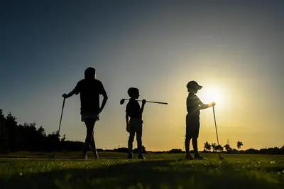 a group of three people playing golf at sunset at Staining Luxury Lodges in Poulton le Fylde