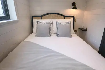 a bed in a small room with two pillows at Staining Luxury Lodges in Poulton le Fylde