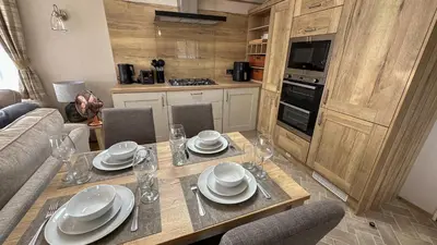 a kitchen with a table with plates and dishes on it at Hobbit - House Of The Owl - Luxury Lodge with Pool in Longridge