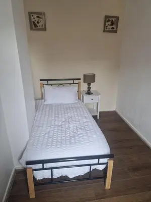 a bedroom with a bed with a white bedspread at Leyland Town Centre Quiet Hub 2 bedroom 4 beds superfast WIFI free parking close to station and High Street in Leyland
