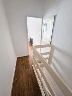 a white room with a bed and a wooden floor at Leyland Town Centre Quiet Hub 2 bedroom 4 beds superfast WIFI free parking close to station and High Street in Leyland