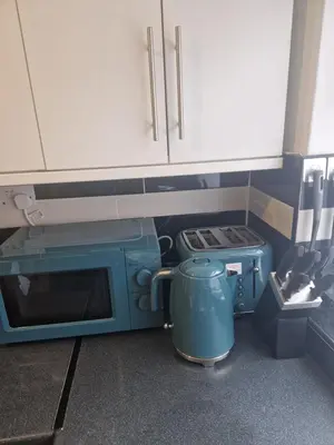 a kitchen with a blue microwave and a stove at Leyland Town Centre Quiet Hub 2 bedroom 4 beds superfast WIFI free parking close to station and High Street in Leyland