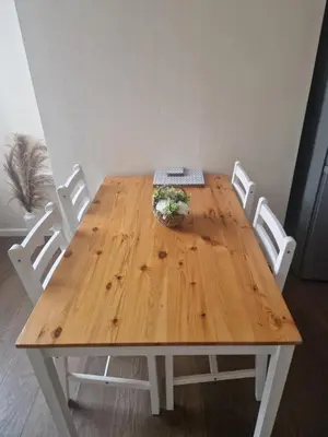 a wooden table with four white chairs around it at Leyland Town Centre Quiet Hub 2 bedroom 4 beds superfast WIFI free parking close to station and High Street in Leyland