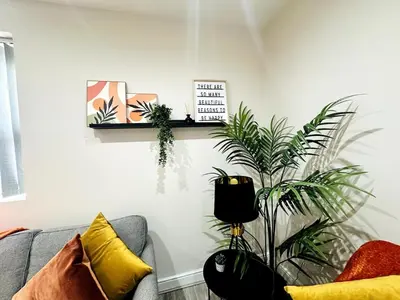 a living room with a couch and some plants at Lovat House - Large 6-Bedroom Property in Preston