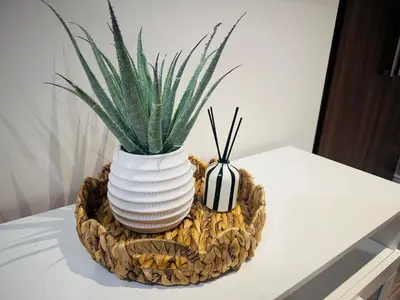 a plant in a white vase on a table at Lovat House - Large 6-Bedroom Property in Preston