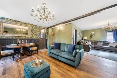 a living room with a couch and a table at The Stables in Poulton le Fylde