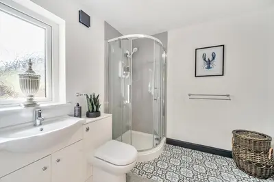 a bathroom with a shower and a toilet and a sink at The Stables in Poulton le Fylde