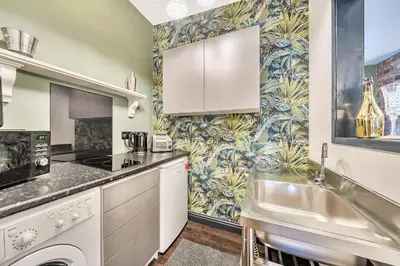 a kitchen with white cabinets and a sink at The Stables in Poulton le Fylde