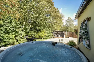 a hot tub in the backyard of a house at The Stables in Poulton le Fylde