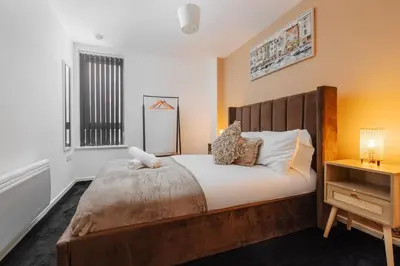 a bedroom with a large bed and a window at City Centre Retreat 2BR 2BA Parking Included in Liverpool
