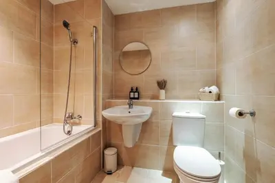 a bathroom with a toilet and a shower and a sink at City Centre Retreat 2BR 2BA Parking Included in Liverpool