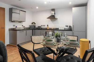 a kitchen and dining room with a table and chairs at City Centre Retreat 2BR 2BA Parking Included in Liverpool