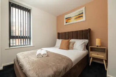 a bedroom with a bed and a window at City Centre Retreat 2BR 2BA Parking Included in Liverpool