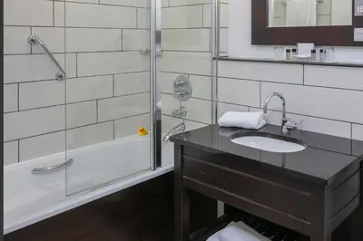 a bathroom with a sink and a shower at Fenwick Street Hotel by EPIC in Liverpool