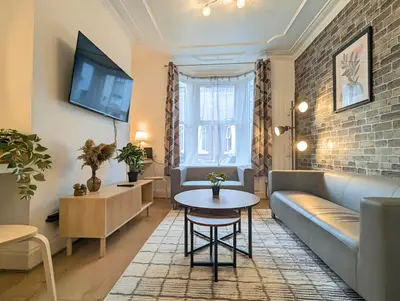 a living room with a couch and a table at Bright 4BR Home Near Anfield & Free Parking in Liverpool