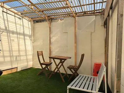 a patio with a table and chairs and a bench at Bright 4BR Home Near Anfield & Free Parking in Liverpool